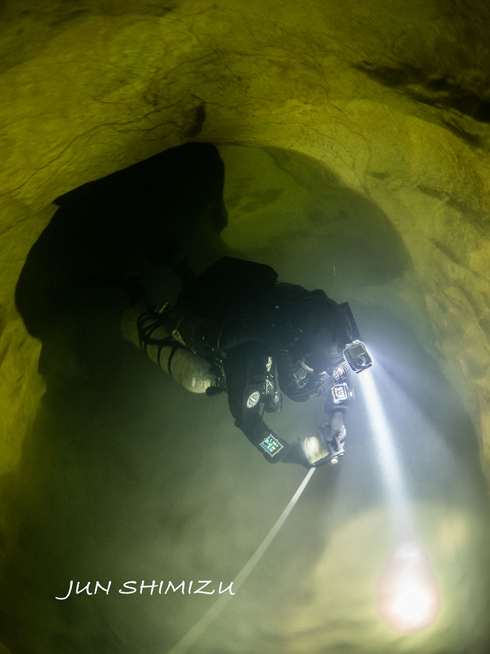 A tubular passageway in the water, suggesting that it was enlarged by the flow of water.